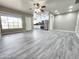 Bright living area with gray floors, recessed lighting, and open layout to the renovated kitchen at 2945 N 19Th Ave # 78, Phoenix, AZ 85015