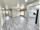 Open living space with modern gray flooring, neutral walls, and easy access to kitchen at 2945 N 19Th Ave # 78, Phoenix, AZ 85015