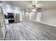 Spacious living room with gray floors, ceiling fan, and open access to the modern kitchen at 2945 N 19Th Ave # 78, Phoenix, AZ 85015