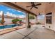 Large covered patio overlooking a stunning backyard with a sparkling pool and lush landscaping at 3135 W Molly Ln, Phoenix, AZ 85083