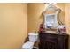 Elegant powder room with decorative mirror, vanity, and neutral wall color at 3135 W Molly Ln, Phoenix, AZ 85083