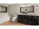 Relaxing bathroom featuring dual sinks, a soaking tub, and stylish decor at 3135 W Molly Ln, Phoenix, AZ 85083