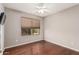 Bedroom featuring a window with blinds, a ceiling fan, and wood flooring at 3135 W Molly Ln, Phoenix, AZ 85083
