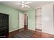 A bedroom with hardwood floors, a ceiling fan, and a closet with sliding doors at 3135 W Molly Ln, Phoenix, AZ 85083