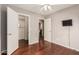 Neutral-toned bedroom with hardwood flooring, closet, and bathroom access at 3135 W Molly Ln, Phoenix, AZ 85083