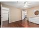 Bedroom with hardwood floors, ceiling fan, closet, and dresser at 3135 W Molly Ln, Phoenix, AZ 85083