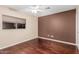 Bedroom with hardwood floors, a ceiling fan, and a large window at 3135 W Molly Ln, Phoenix, AZ 85083