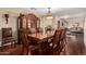 Formal dining room featuring hardwood floors, a large china cabinet, and an elegant chandelier at 3135 W Molly Ln, Phoenix, AZ 85083