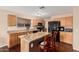 Bright kitchen boasts granite counters, wood cabinets, breakfast bar, and modern black appliances at 3135 W Molly Ln, Phoenix, AZ 85083