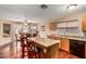 Eat-in kitchen features a breakfast bar, updated appliances, granite countertops, and a seamlessly connects to dining area at 3135 W Molly Ln, Phoenix, AZ 85083