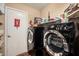 Convenient laundry room with modern washer and dryer units, plus ample storage and safety features at 3135 W Molly Ln, Phoenix, AZ 85083