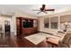 Cozy living room featuring hardwood floors, a decorative rug, and a wall-mounted TV at 3135 W Molly Ln, Phoenix, AZ 85083