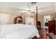Spacious bedroom featuring a four poster bed, hardwood floors, and ensuite bathroom at 3135 W Molly Ln, Phoenix, AZ 85083