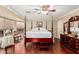 Spacious main bedroom featuring a four poster bed, hardwood floors, and lots of natural light at 3135 W Molly Ln, Phoenix, AZ 85083