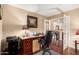 Cozy home office with dark wood desk, comfortable leather chair, and french doors at 3135 W Molly Ln, Phoenix, AZ 85083