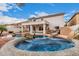 Backyard view showcasing a custom pool and spa with rock features, plus outdoor seating area at 3135 W Molly Ln, Phoenix, AZ 85083