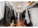 Organized walk-in closet with ample storage space and hardwood floors at 3135 W Molly Ln, Phoenix, AZ 85083