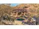 Stunning aerial view of property highlighting its secluded pool area, red tile roof, lush landscaping, and peaceful desert setting at 3201 N 91St St, Mesa, AZ 85207