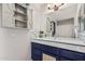 Bathroom featuring white countertops, shaker cabinets, large mirror, and modern decor at 3201 N 91St St, Mesa, AZ 85207