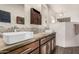 Modern bathroom featuring double sinks, vessel sinks, stone backsplash, and a walk-in shower at 3201 N 91St St, Mesa, AZ 85207