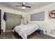 Cozy bedroom with a ceiling fan, vinyl floors, neutral colors, and lots of light at 3201 N 91St St, Mesa, AZ 85207