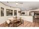 Inviting dining area featuring tile flooring, a round table with bench seating, and views of the surrounding landscape at 3201 N 91St St, Mesa, AZ 85207