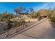 Long driveway leading to a secluded desert home with lush landscaping and ample parking space at 3201 N 91St St, Mesa, AZ 85207