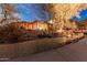Expansive exterior view featuring a multi-story home with desert landscaping, a pergola and lighting at 3201 N 91St St, Mesa, AZ 85207