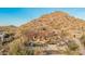Custom home nestled into mountain views with a red roof, pool, and scenic landscaping at 3201 N 91St St, Mesa, AZ 85207