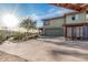 House with green exterior and spacious driveway, with garage and covered carport and desert scenery in the background at 3201 N 91St St, Mesa, AZ 85207