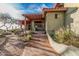 Inviting front entrance with a charming walkway and lush desert landscaping under a covered patio, ideal for outdoor relaxation at 3201 N 91St St, Mesa, AZ 85207