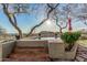 Raised hot tub featuring stone accents and surrounding greenery, set against a backdrop of picturesque desert views at 3201 N 91St St, Mesa, AZ 85207