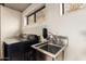 Laundry room featuring a sink, window, and a stainless steel faucet at 3201 N 91St St, Mesa, AZ 85207