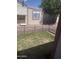 Fenced backyard with small lawn and partial shade from mature tree offers outdoor relaxation at 3330 E Main St # 332, Mesa, AZ 85213