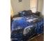 Cozy bedroom with a unique wolf-themed bedding set and natural light from the window at 3330 E Main St # 332, Mesa, AZ 85213