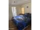 Bedroom featuring wolf themed bedding, laminate flooring, and natural light from the window at 3330 E Main St # 332, Mesa, AZ 85213
