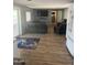 Comfortable living room featuring modern flooring, a flat-screen TV, and a sliding glass door for plenty of natural light at 3330 E Main St # 332, Mesa, AZ 85213