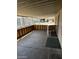 Covered back porch with wood-look fencing and a view of a nearby car at 3330 E Main St # 332, Mesa, AZ 85213