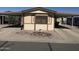 Charming home featuring a covered carport, rock landscaping, and neutral colored exterior at 3330 E Main St # 332, Mesa, AZ 85213