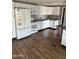 Bright kitchen with white appliances and white cabinets, plus wood-look vinyl flooring at 3330 E Main St # 332, Mesa, AZ 85213