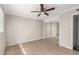 Neutral bedroom with a ceiling fan, tiled floors, and closet with sliding doors at 3707 W Elm St, Phoenix, AZ 85019