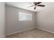 Neutral bedroom featuring ceiling fan and window with blinds at 3707 W Elm St, Phoenix, AZ 85019