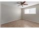 Cozy bedroom with a ceiling fan, neutral walls, and bright natural light at 3707 W Elm St, Phoenix, AZ 85019