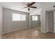 Neutral bedroom featuring mirrored closet doors, ceiling fan, and natural light at 3707 W Elm St, Phoenix, AZ 85019