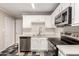 Well-lit kitchen features modern stainless steel appliances and white cabinets at 3707 W Elm St, Phoenix, AZ 85019