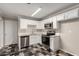 Clean and bright kitchen with stainless steel appliances and a white color scheme at 3707 W Elm St, Phoenix, AZ 85019