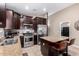 A modern kitchen featuring stainless steel appliances, granite countertops, and an island with seating at 39984 W Hopper Dr, Maricopa, AZ 85138