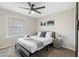 Bedroom with queen bed, bedside tables, ceiling fan, large window and modern wall decorations at 4129 W Caron St, Phoenix, AZ 85051