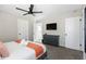 Neutral bedroom featuring a queen size bed, ceiling fan, dresser, and flat screen TV at 4129 W Caron St, Phoenix, AZ 85051