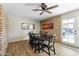 Inviting dining area with hardwood floors, exposed brick, and stylish lighting, perfect for entertaining at 4129 W Caron St, Phoenix, AZ 85051